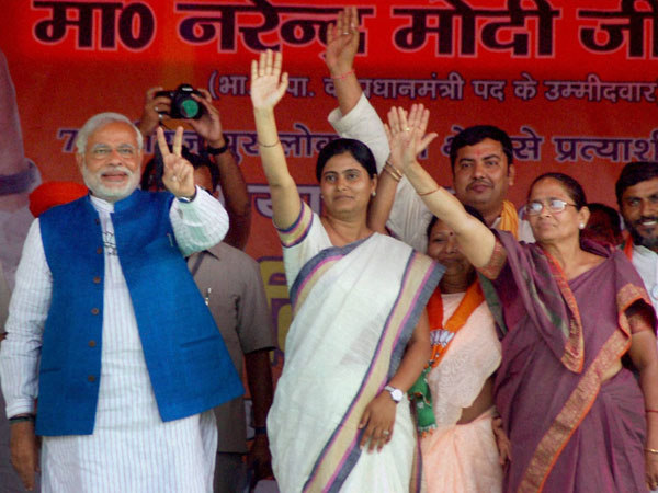 Narendra Modi flashes victory sign
