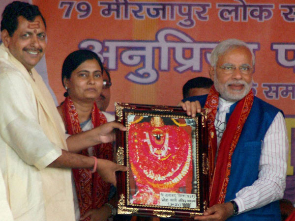 Narendra Modi is presented a memento at an election rally