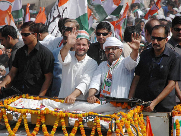 Rahul Gandhi waves to the crowd at a road show
