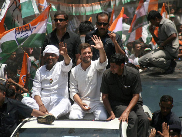 Rahul Gandhi waves to the crowd at a road show