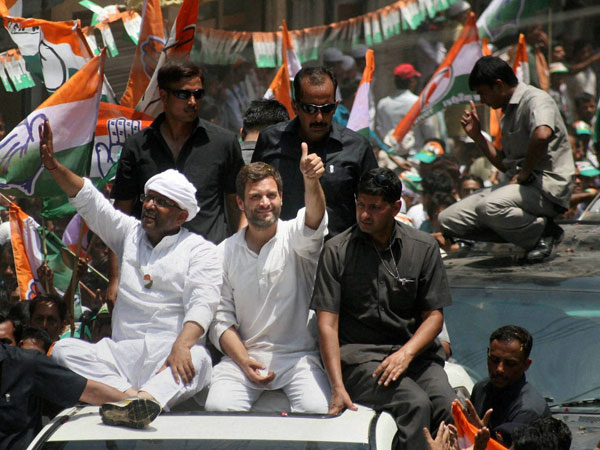 Rahul Gandhi waves to the crowd at a road show