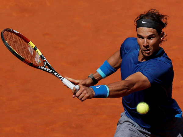 Rafael Nadal from Spain returns the ball during a Madrid Open tennis tournament Rafael Nadal from Spain returns the ball during a Madrid Open tennis tournament