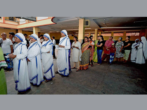 Missionaries of Charity nuns standing in a queue to cast their votes