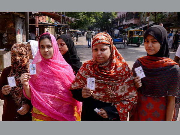 Muslim women voters showing their voter ID cards