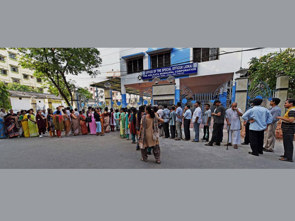 Voters standing in queue to cast their votes at a polling station