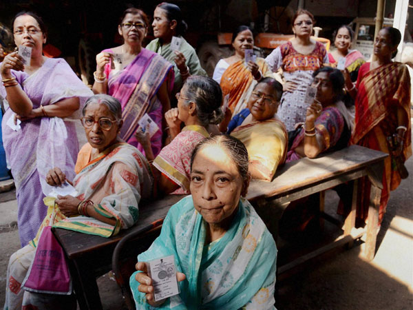 Elderly women voters wait to cast their votes