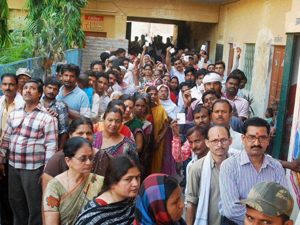 Voters stand in long queues to cast their votes