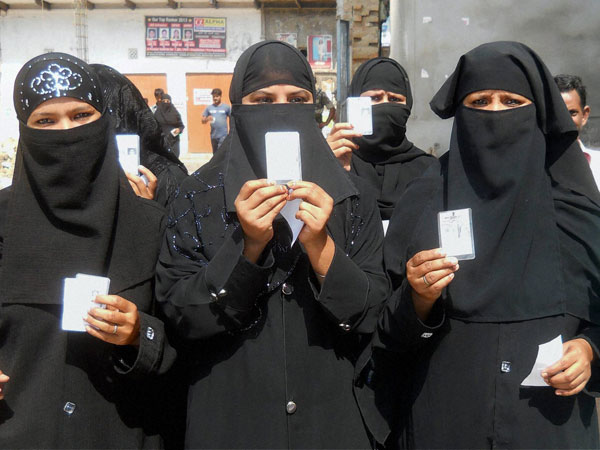 Muslim women arrive to cast their votes