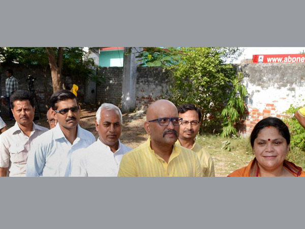 Congress candidate Ajay Rai wait in a queue to cast his vote