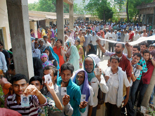 Voters stand in long queues to cast their votes