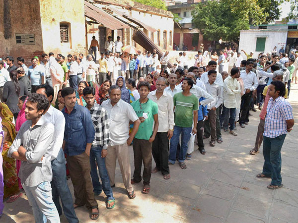 Voters stand in long queues to cast their votes