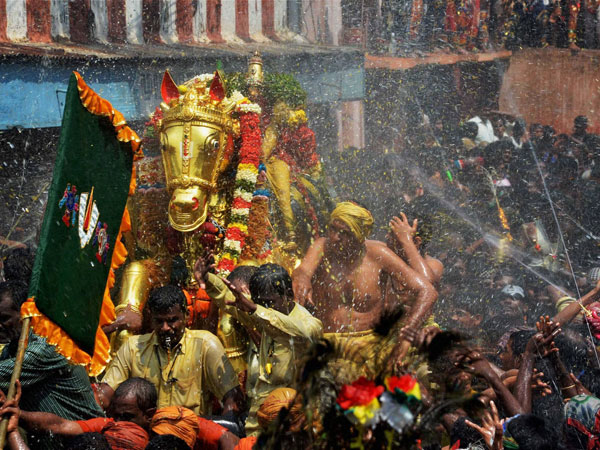 Devotees perform holy bath of the idol of Lord Kallazhagar 