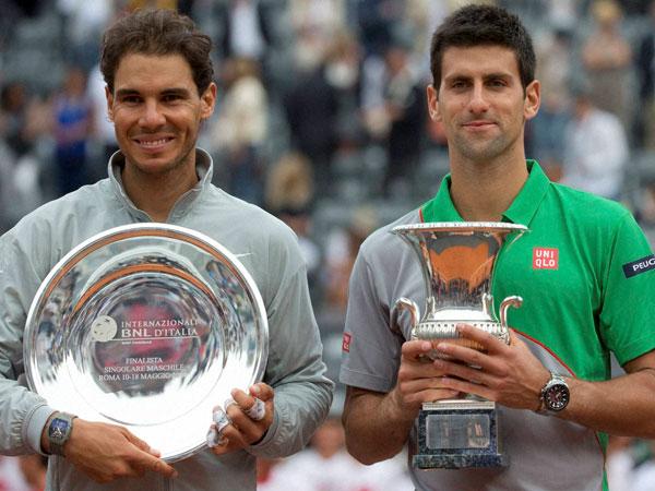 Serbia's Novak Djokovic, right, holds the winner's trophy