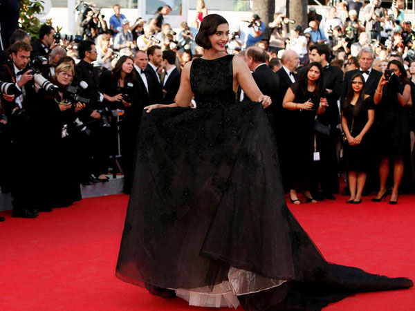 Actress Sonam Kapoor poses for photographers