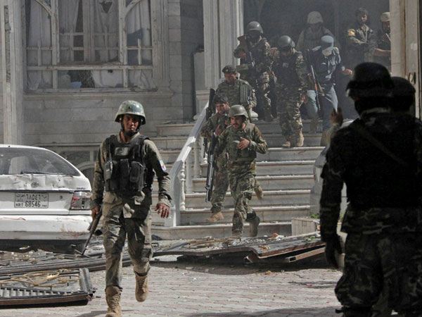 Afghanistan's National Army (ANA) soldiers walk at the site