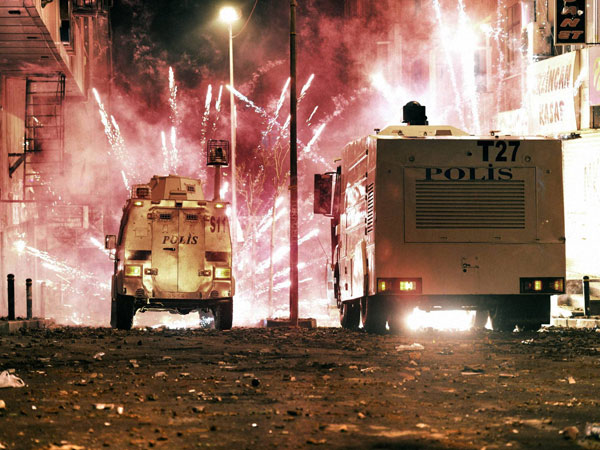 Riot police use water cannons and teargas to disperse people
