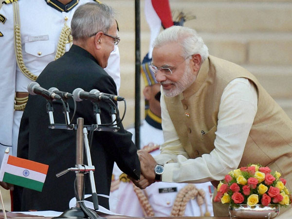 President Pranab Mukherjee greets Prime Minister Narendra Modi