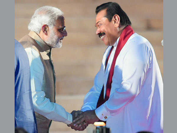 Prime Minister Narendra Modi is greeted by Sri Lankan President Mahinda Rajapaksa