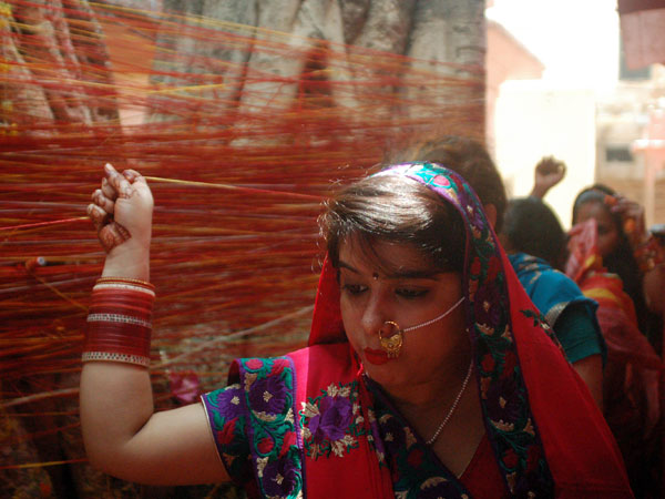 A woman performs rituals on Vat-Savitri Puja in Varanasi 