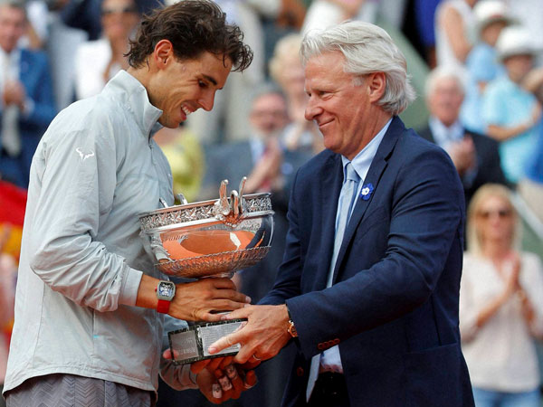 Spain's Rafael Nadal, left, gets the cup from Swedish tennis legend 