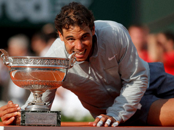Spain's Rafael Nadal bites the trophy