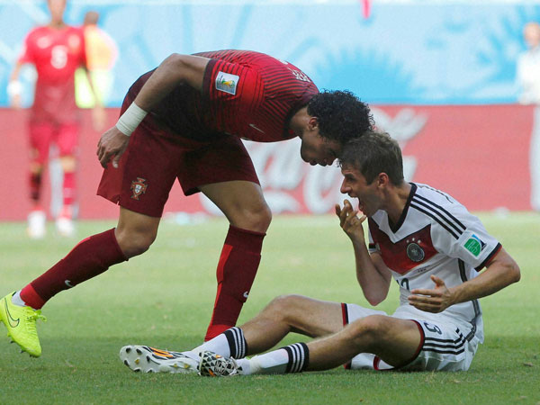 Portugal's Pepe, left, puts his head on Germany's Thomas Mueller