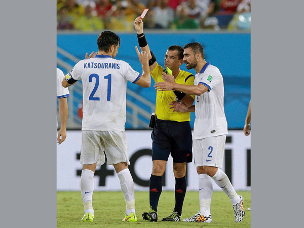 Referee Joel Aguilar from El Salvador shows a red card