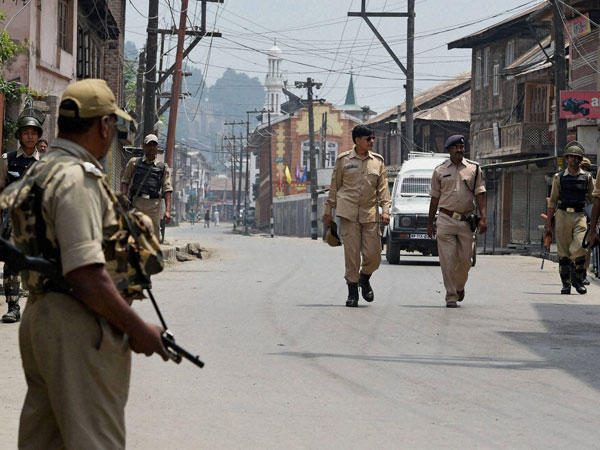 Security personnel petrolling a street in downtown Srinagar