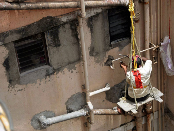 A BMC employee disconnects the water supply to the Campa Cola Society