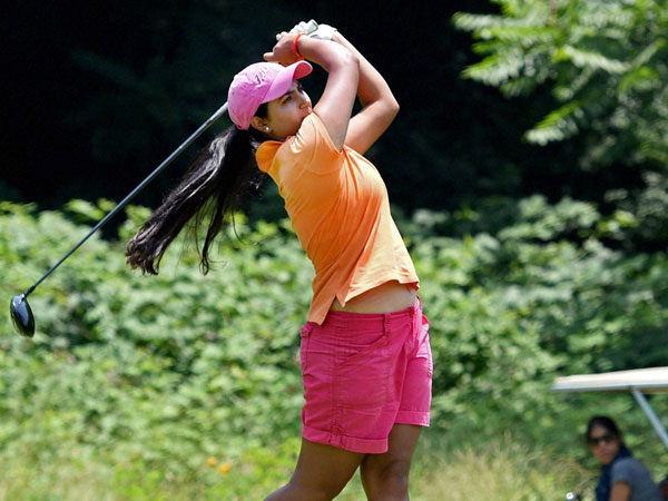 A woman player tees off during a golf event at Royal Spring Golf 