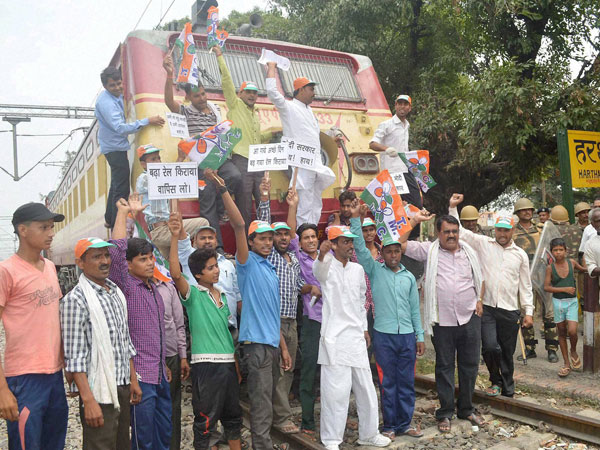 Trinamool Congress workers stop a train to protest 