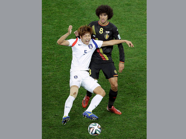 South Korea's Kim Young-gwon, left, shouts out