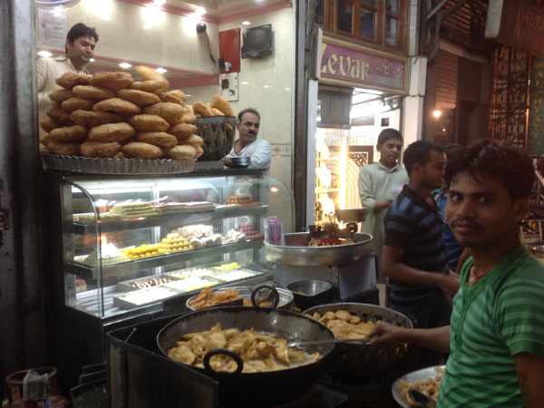 A young boy sells chicken biryani outside Jama Masjid