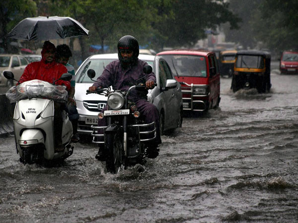 Vehicles move through a waterlogged road