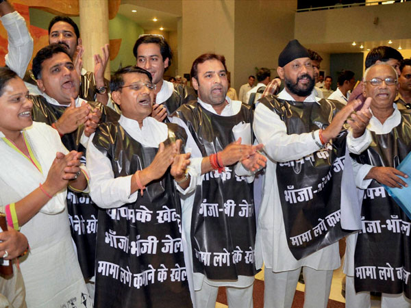 Opposition Congress MLAs, wearing black jackets, raise slogans