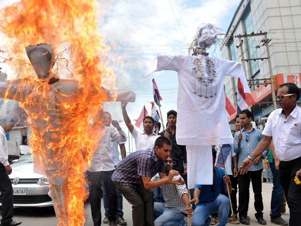 Asom Gana Parishad (AGP) activists burn effigies of Assam Chief Minister Tarun Gogoi