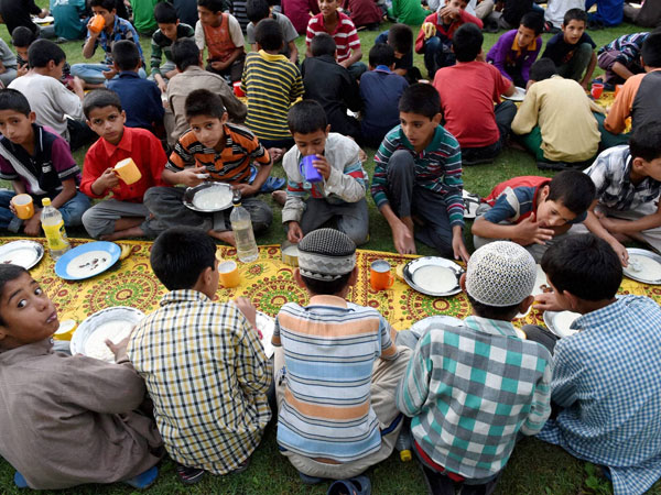 Inmates of an orphanage breaking their fast on 5th day