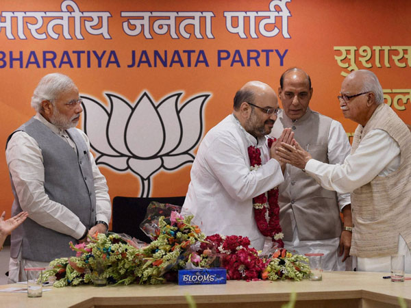 BJP President Amit Shah is greeted by senior leader LK Advani