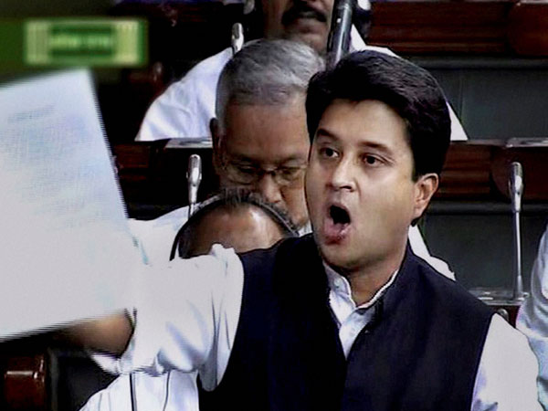 Congress leader Jyotiraditya Scindia shows a document 