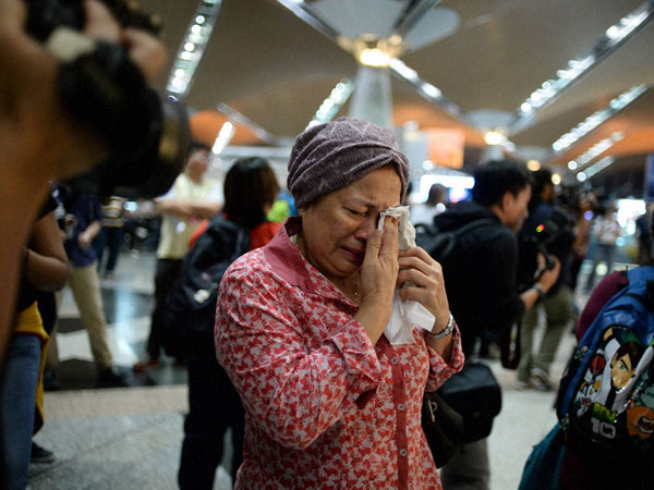 A woman reacts to news regarding a Malaysia Airlines 