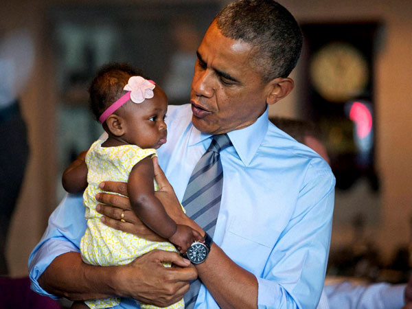President Barack Obama holds seven-month-old Jaidyn Oates