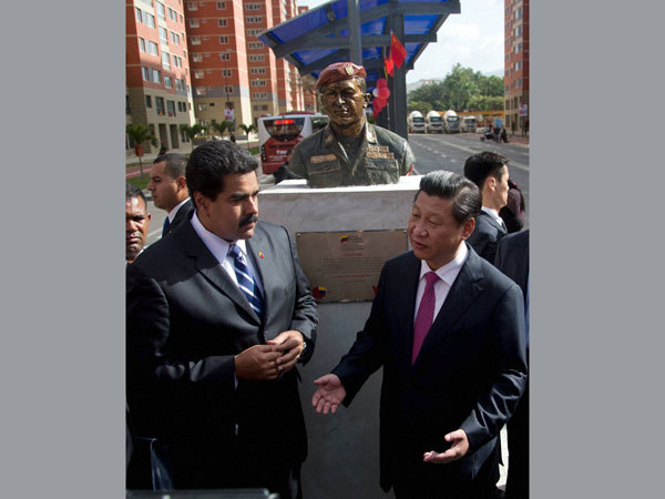 China's President Xi Jinping, right, and Venezuela's President Nicolas Maduro speak