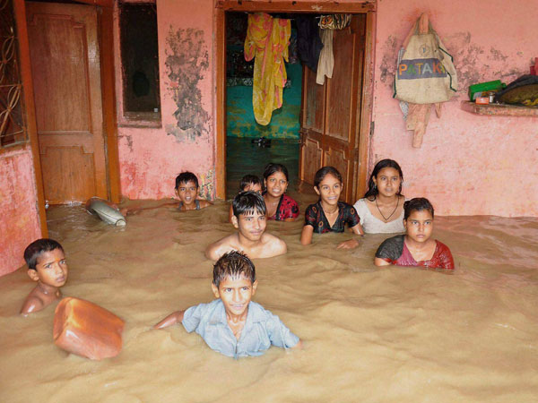 Children in a locality flooded by Ramganga River