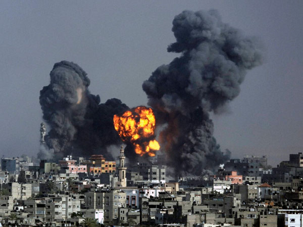 Smoke and fire from the explosion of an Israeli strike rise over Gaza
