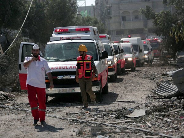 A Palestinian rescue convoy navigates rubble in Gaza City