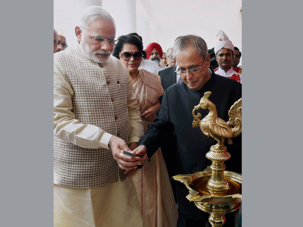President Pranab Mukherjee with Prime Minister Narendra Modi lighting the lamp