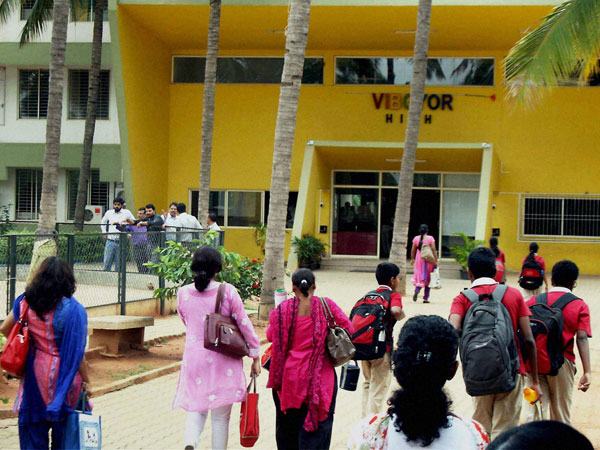 Students and staff arrive at the Vibgyor High School 