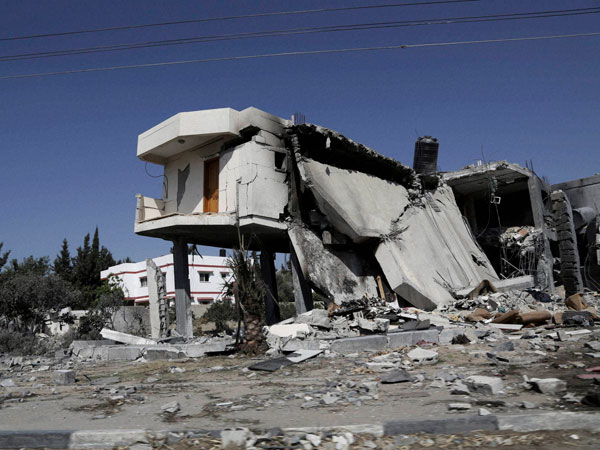 An abandoned Palestinian home destroyed by Israeli strikes