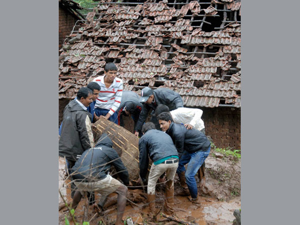 Rescue workers clear the debris at the site of a landslide