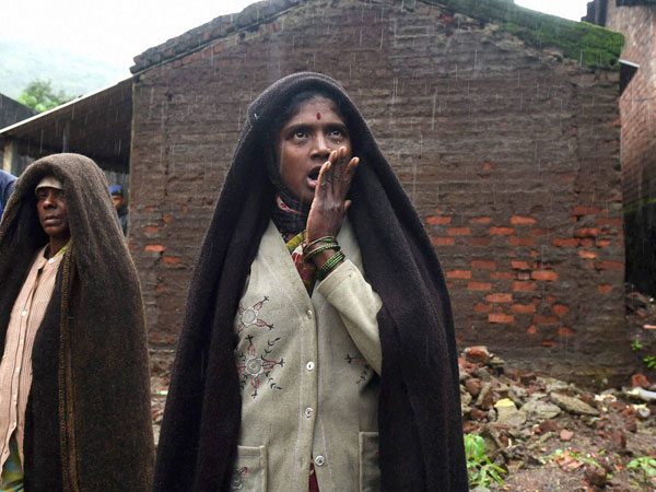Relative of a landslide victim at Malin village in Pune